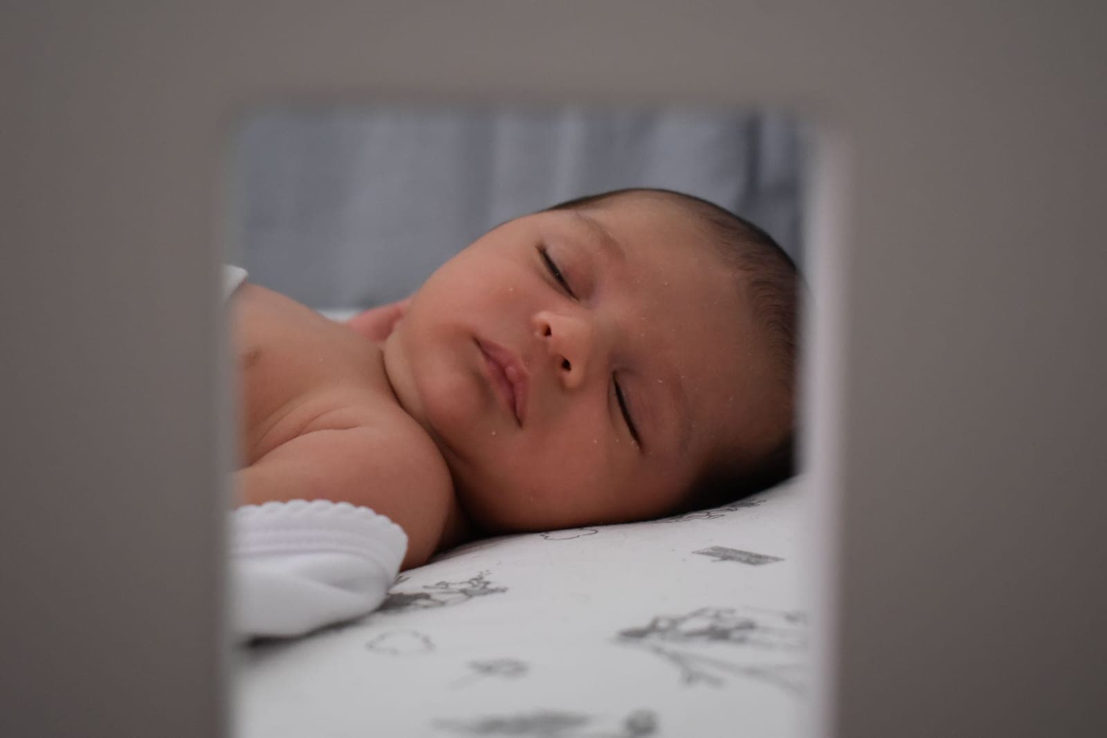 A sleeping baby lying peacefully indoors in soft light