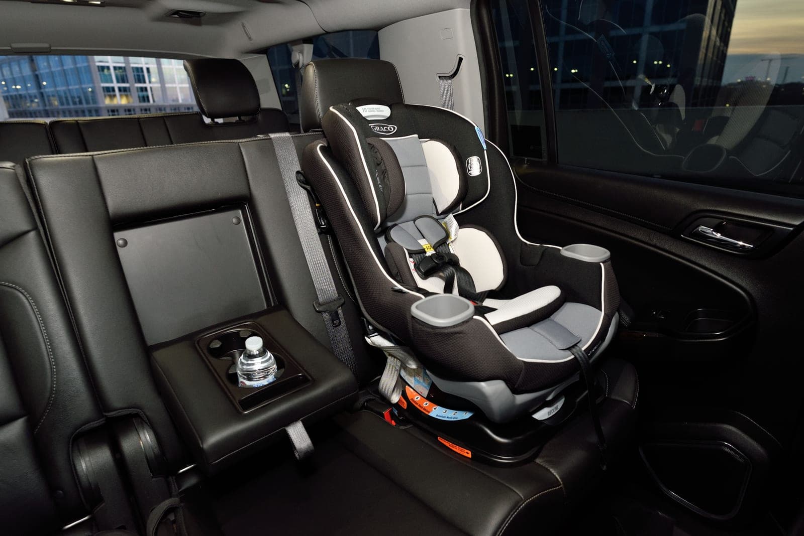 A child safety seat installed in the back seat of a car