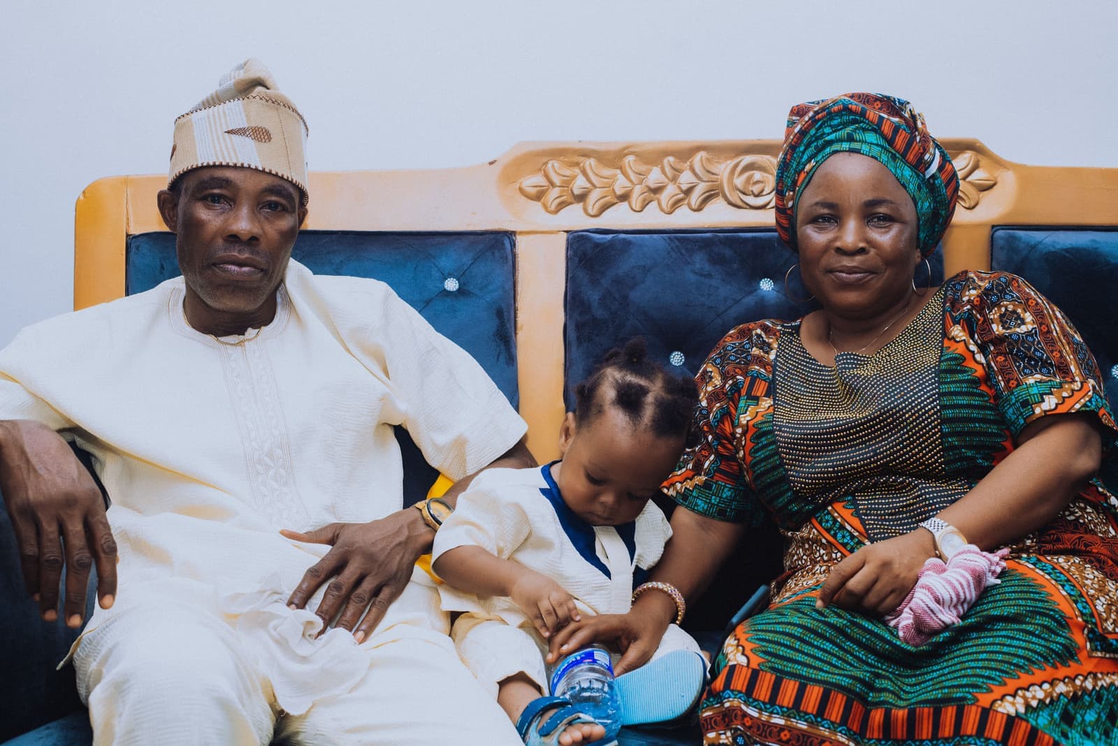 A family sitting together on a couch in a living room